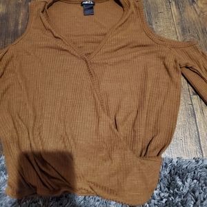 A brown shirt with shoulder exposed sleeve